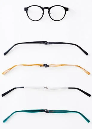 Óculos de leitura com ímãs: armação preta redonda e quatro hastes magnéticas intercambiáveis (preta, madeira, branca, verde).