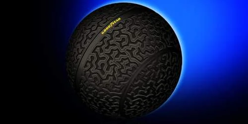Pneu esférico Goodyear, com banda de rodagem, flutuando por levitação magnética em fundo azul.