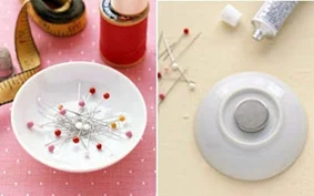 Tigela branca com alfinetes coloridos e outra tigela com ímã em sua base, mostrando utilidades para ímãs que talvez você não tenha pensado antes.